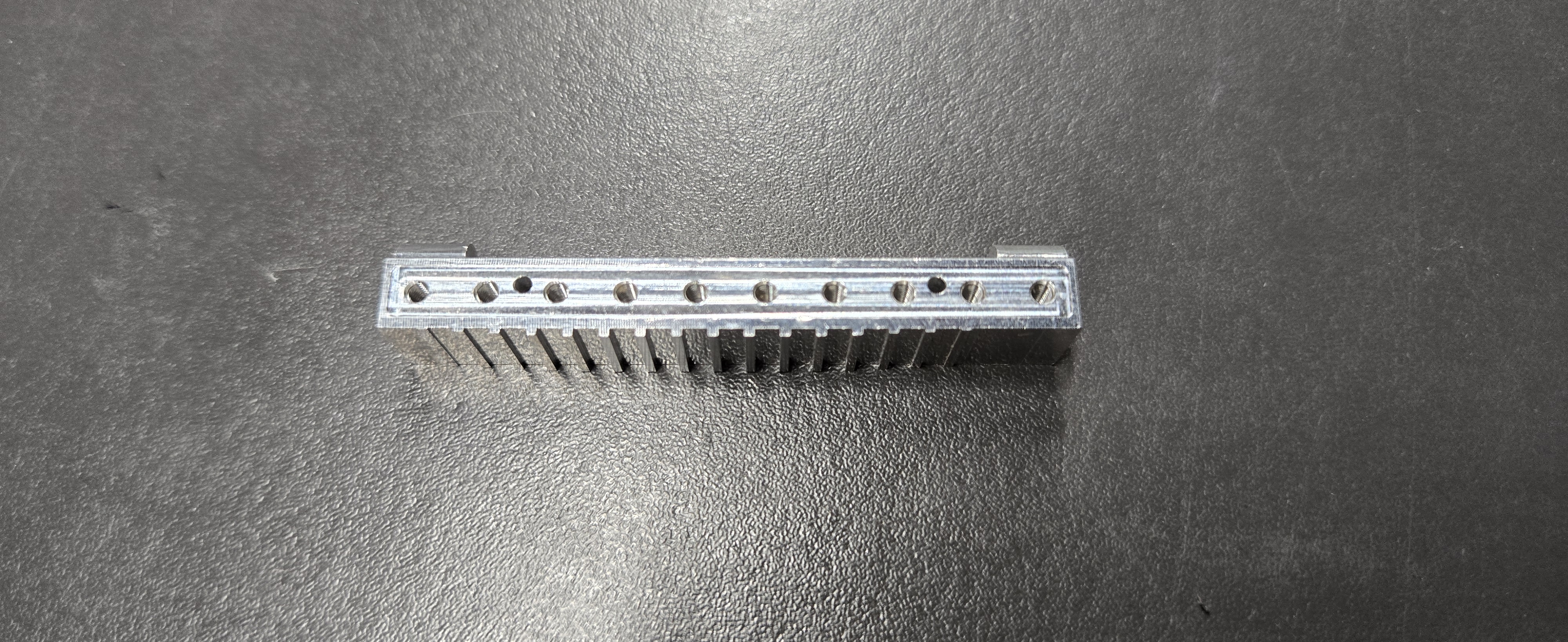 Precision machined comb-style aluminum component