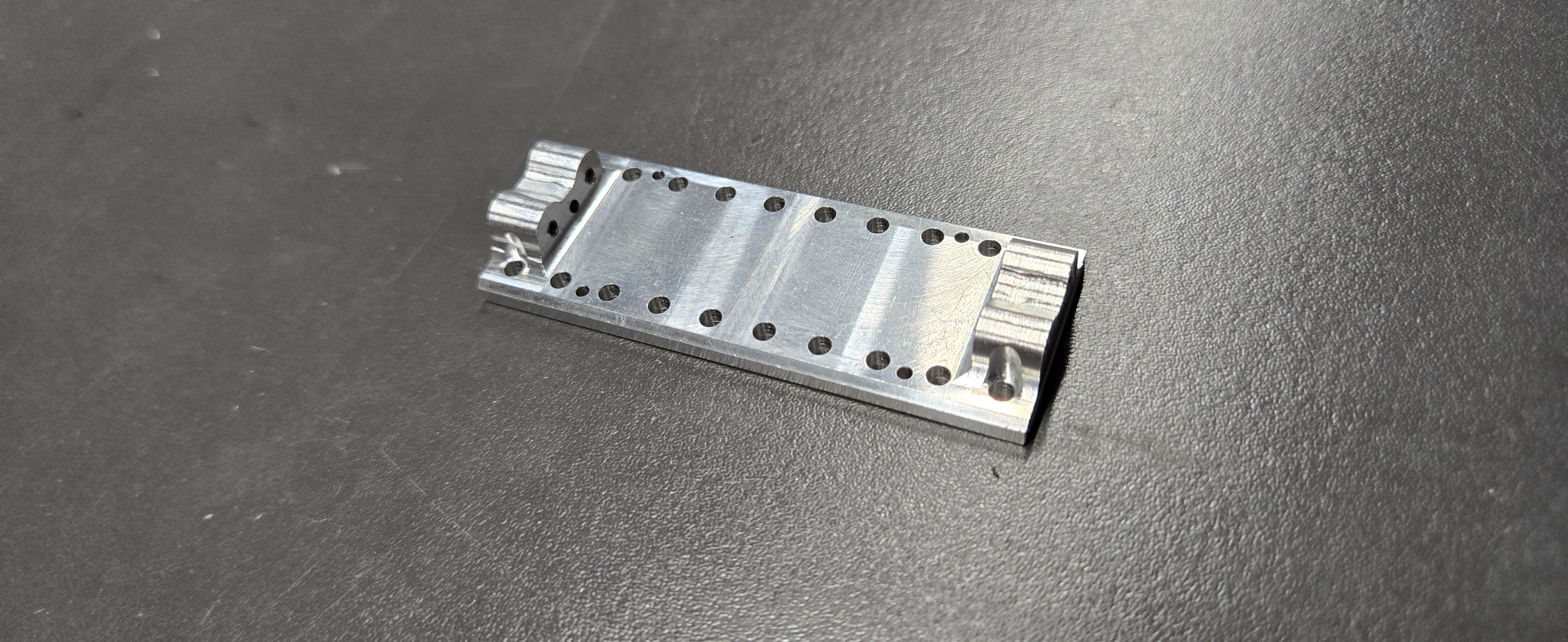 CNC milled mounting plate with multiple drilled holes